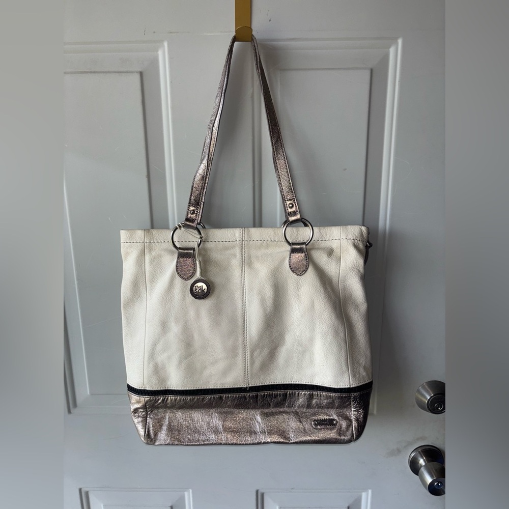 The Sak ivory/gold leather tote